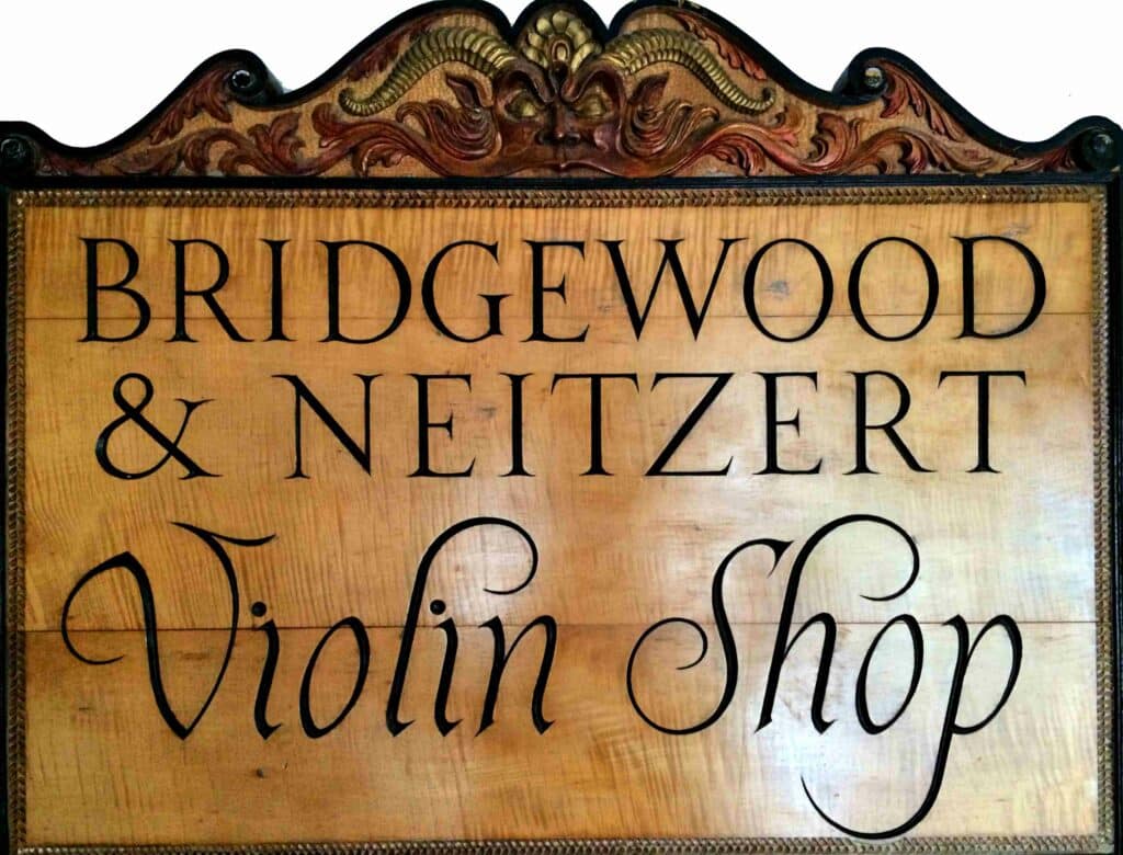 Shop sign carved out of fiddle back maple by Tom and Gary